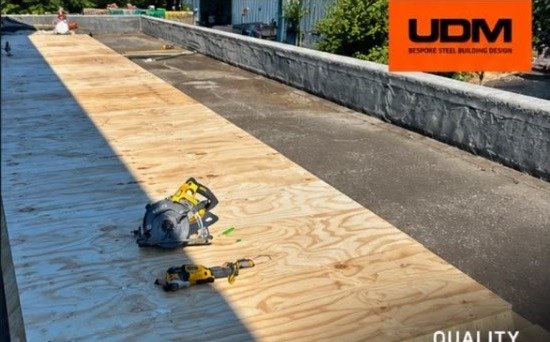 New plywood roof decking being installed during the flat roof refurbishment