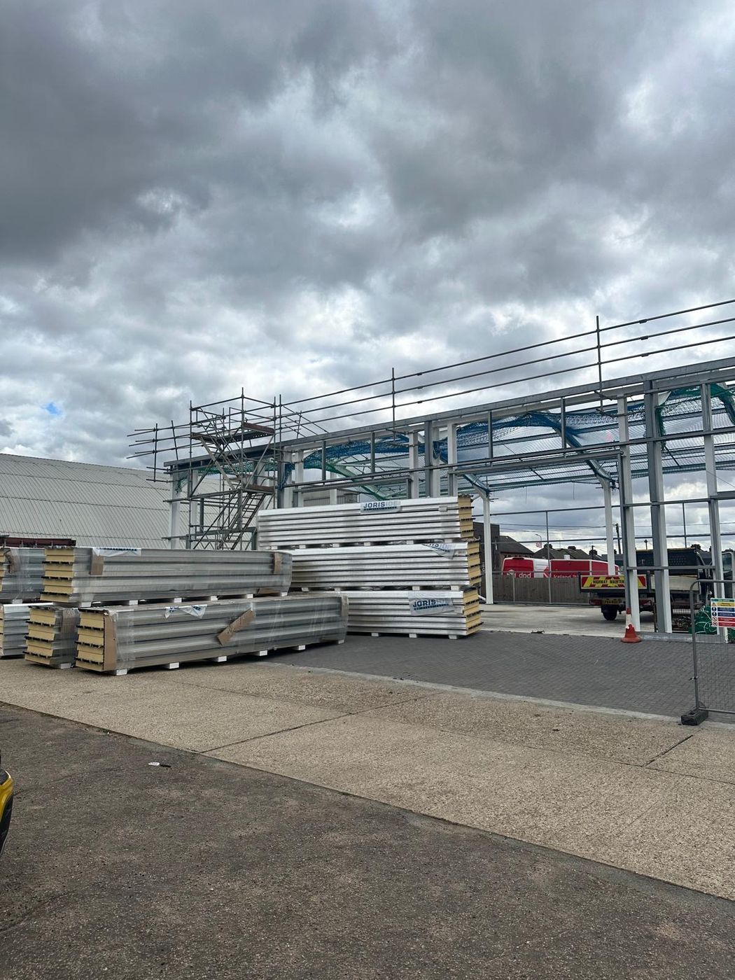 Stacks of insulated cladding panels awaiting installation
